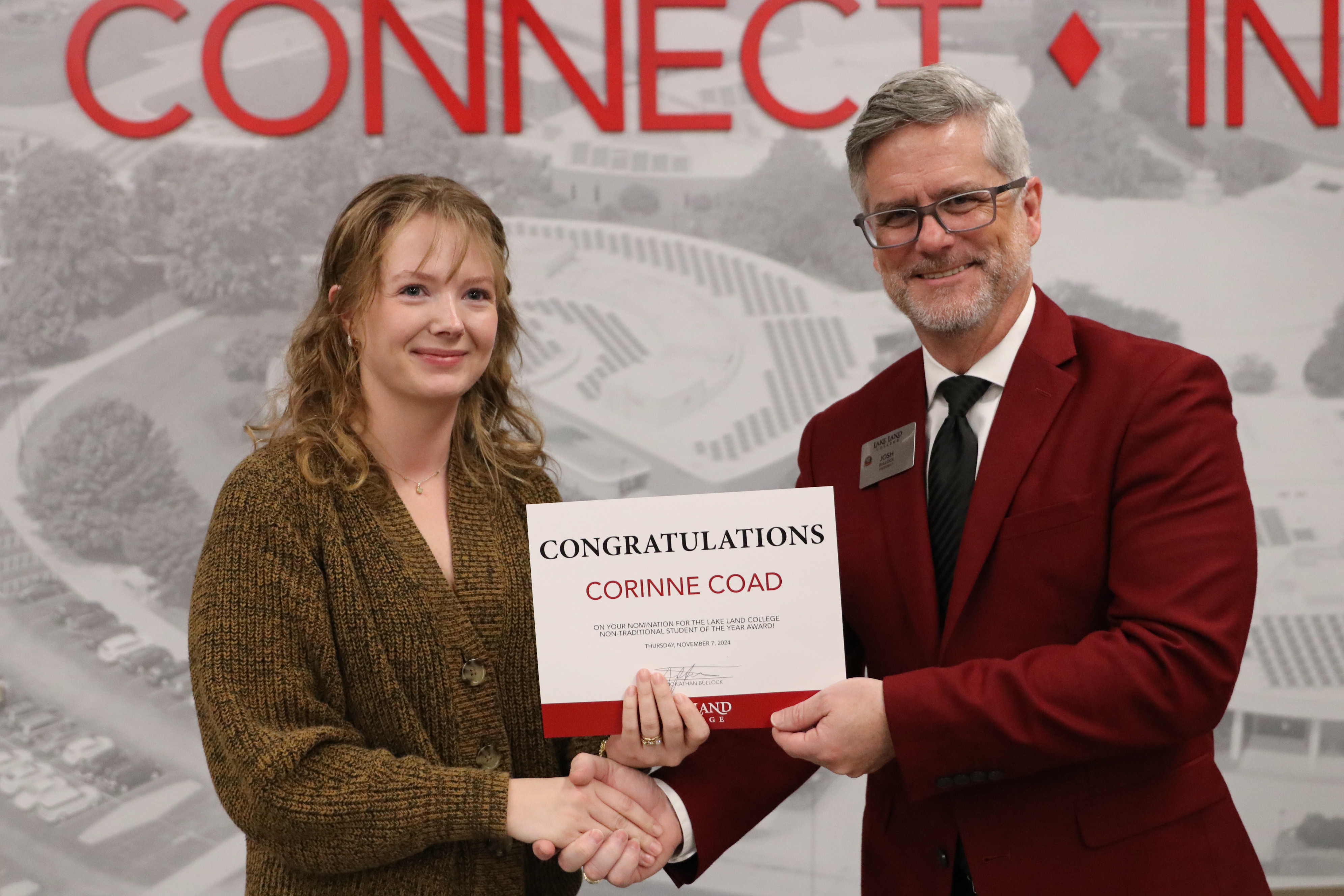 A non-traditional student is recognized during a ceremony