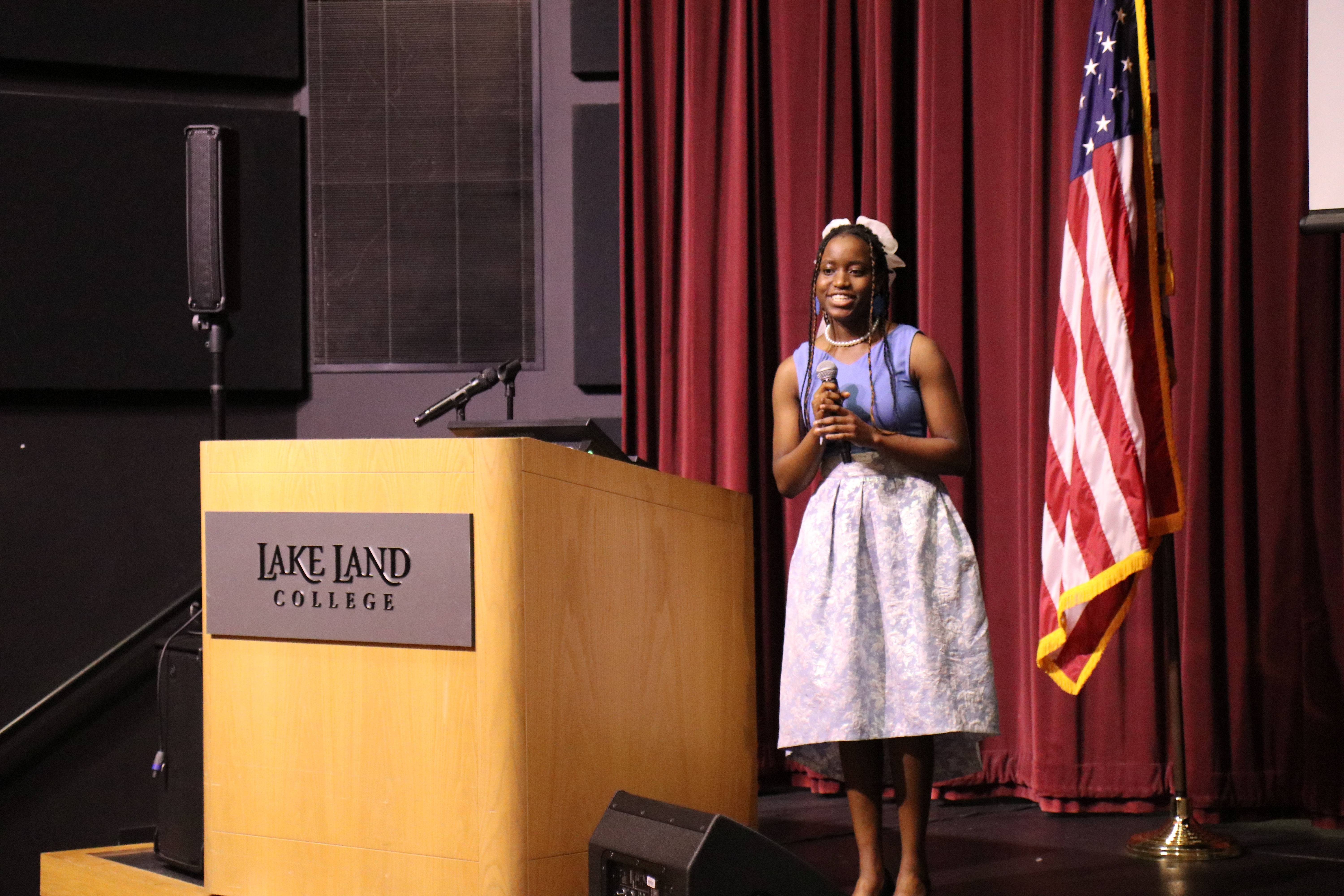 An international student presents during a ceremony. 