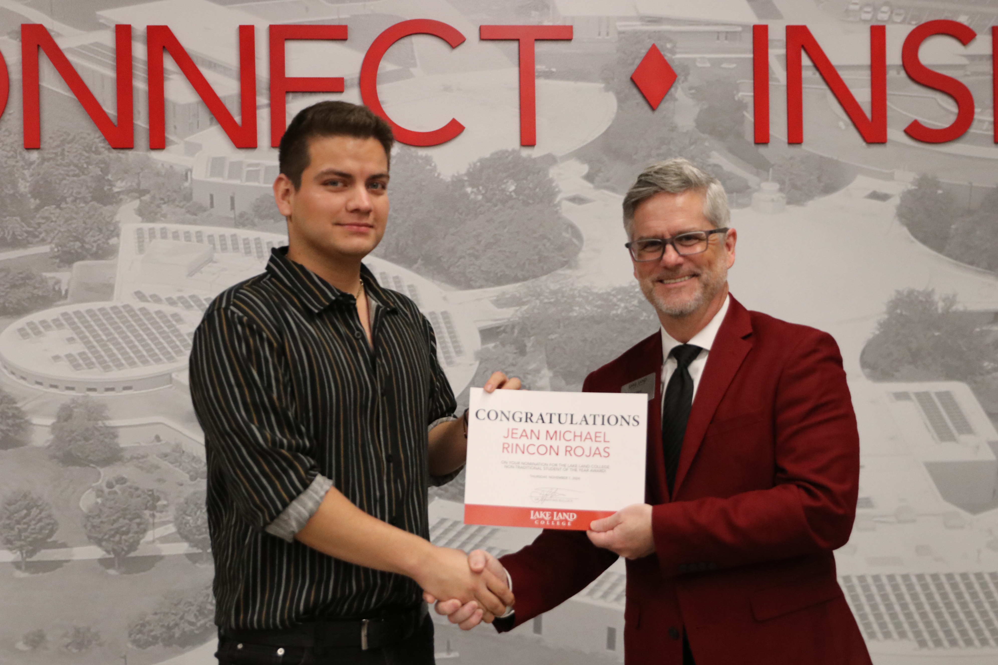 A non-traditional student is recognized during a ceremony