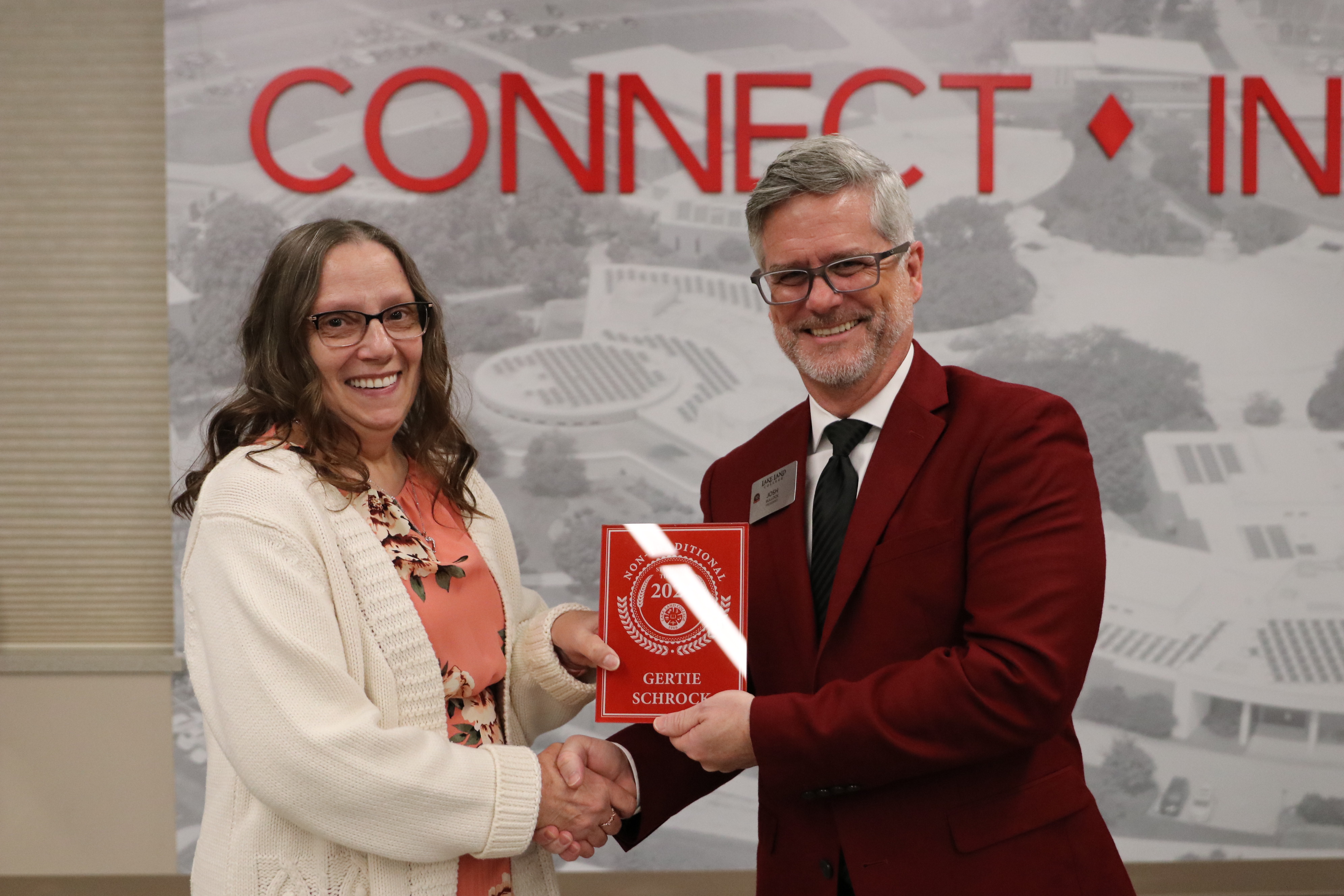 A non-traditional student accepts the 2024 non-traditional student of the year award